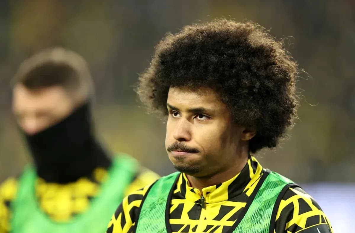 Player in yellow and green kit during match warm-up Player in yellow and green kit during match warm-up