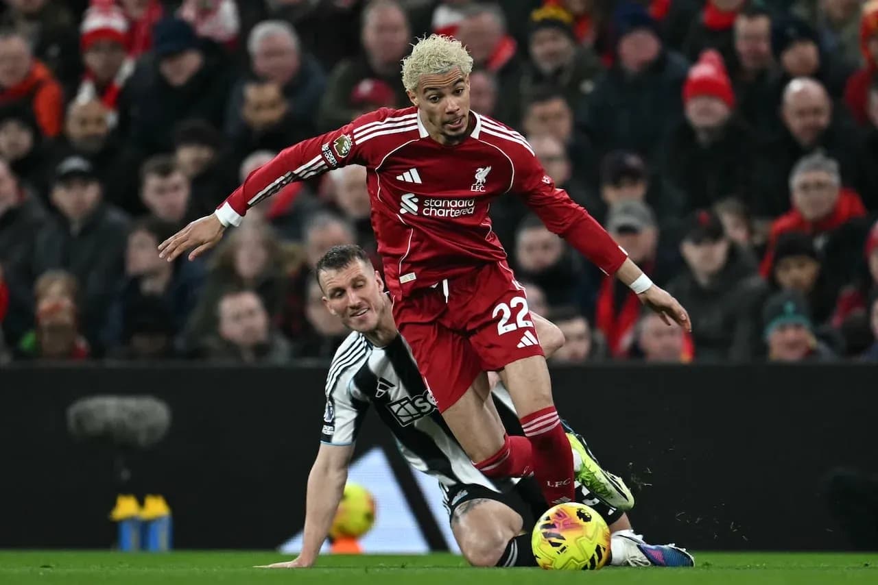 Liverpool player tackled by Newcastle opponent Liverpool player tackled by Newcastle opponent
