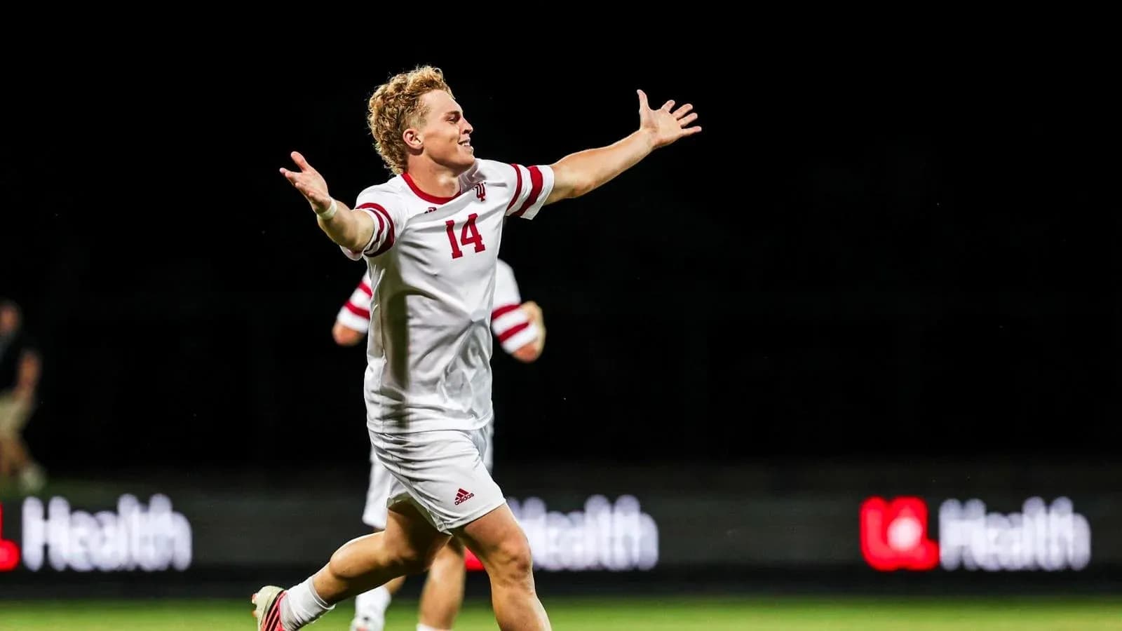 Soccer player celebrating with arms outstretched Soccer player celebrating with arms outstretched