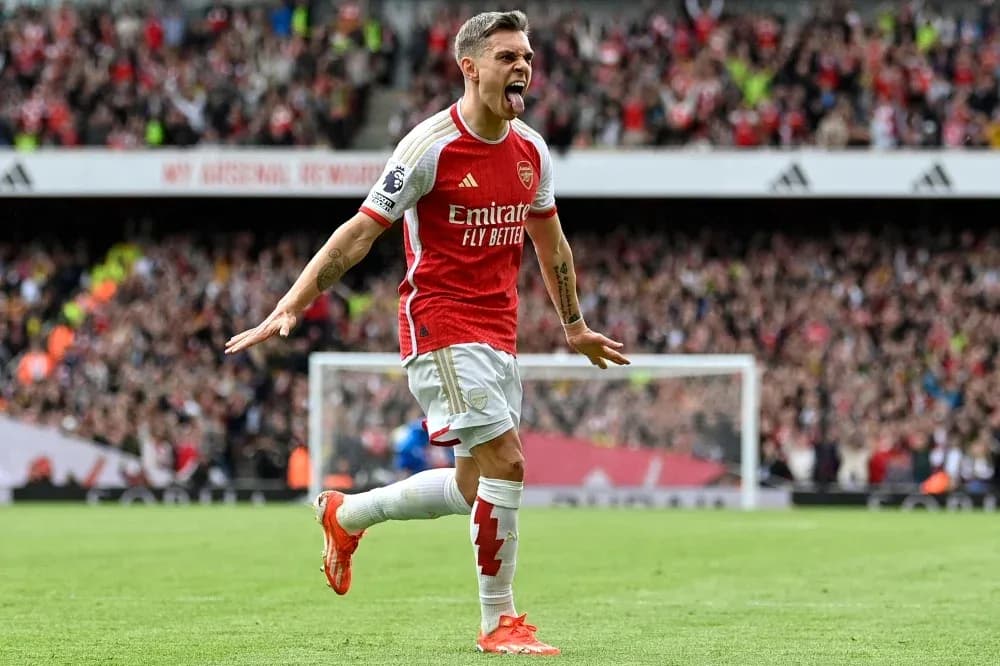 Arsenal player celebrating a goal with fans Arsenal player celebrating a goal with fans