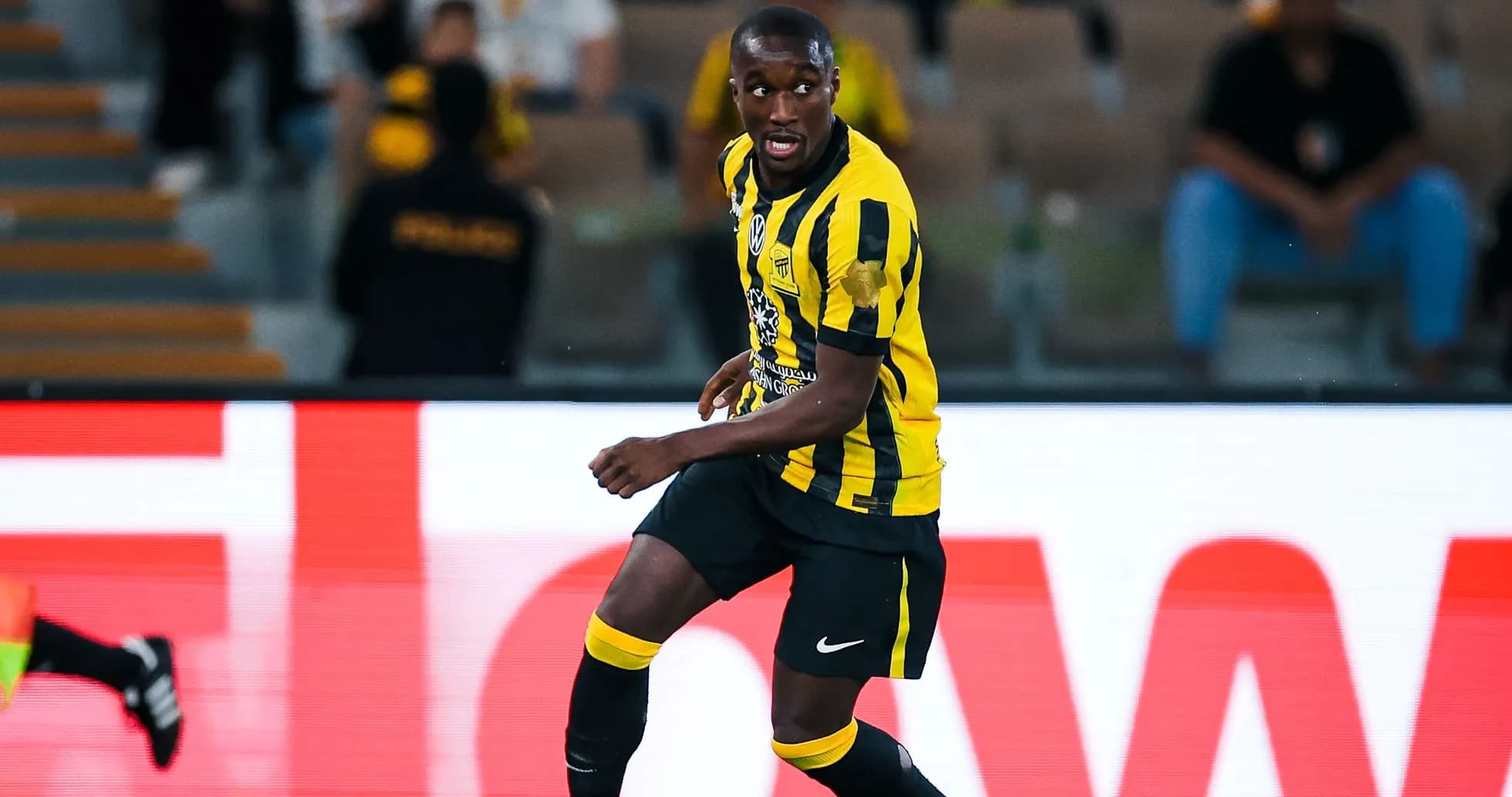 Player in yellow and black kit dribbling the ball Player in yellow and black kit dribbling the ball