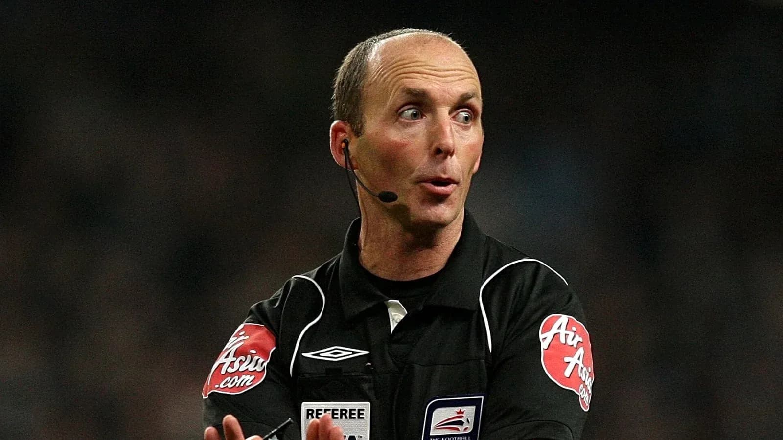 Referee officiating a match with a microphone Referee officiating a match with a microphone