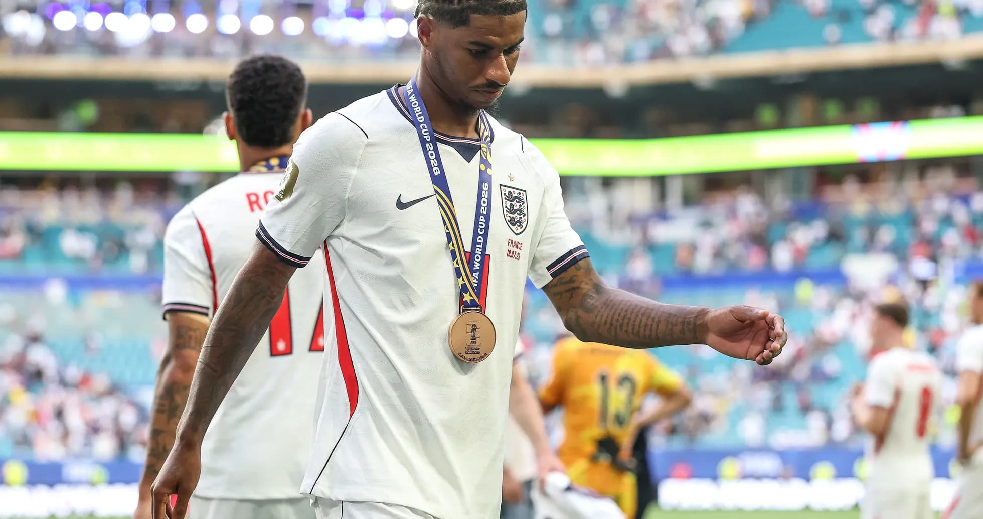 Player walking off field with bronze medal after match Player walking off field with bronze medal after match