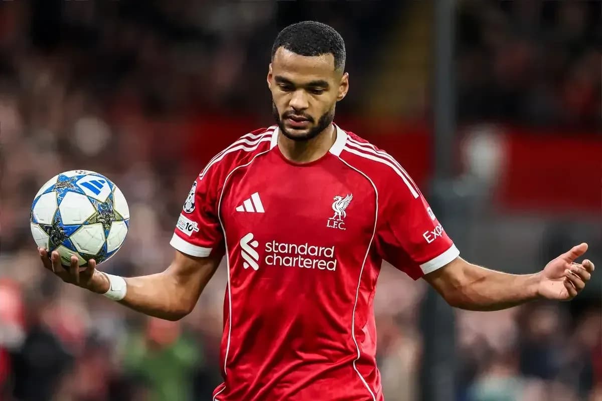 Player in red Liverpool kit holding a football Player in red Liverpool kit holding a football