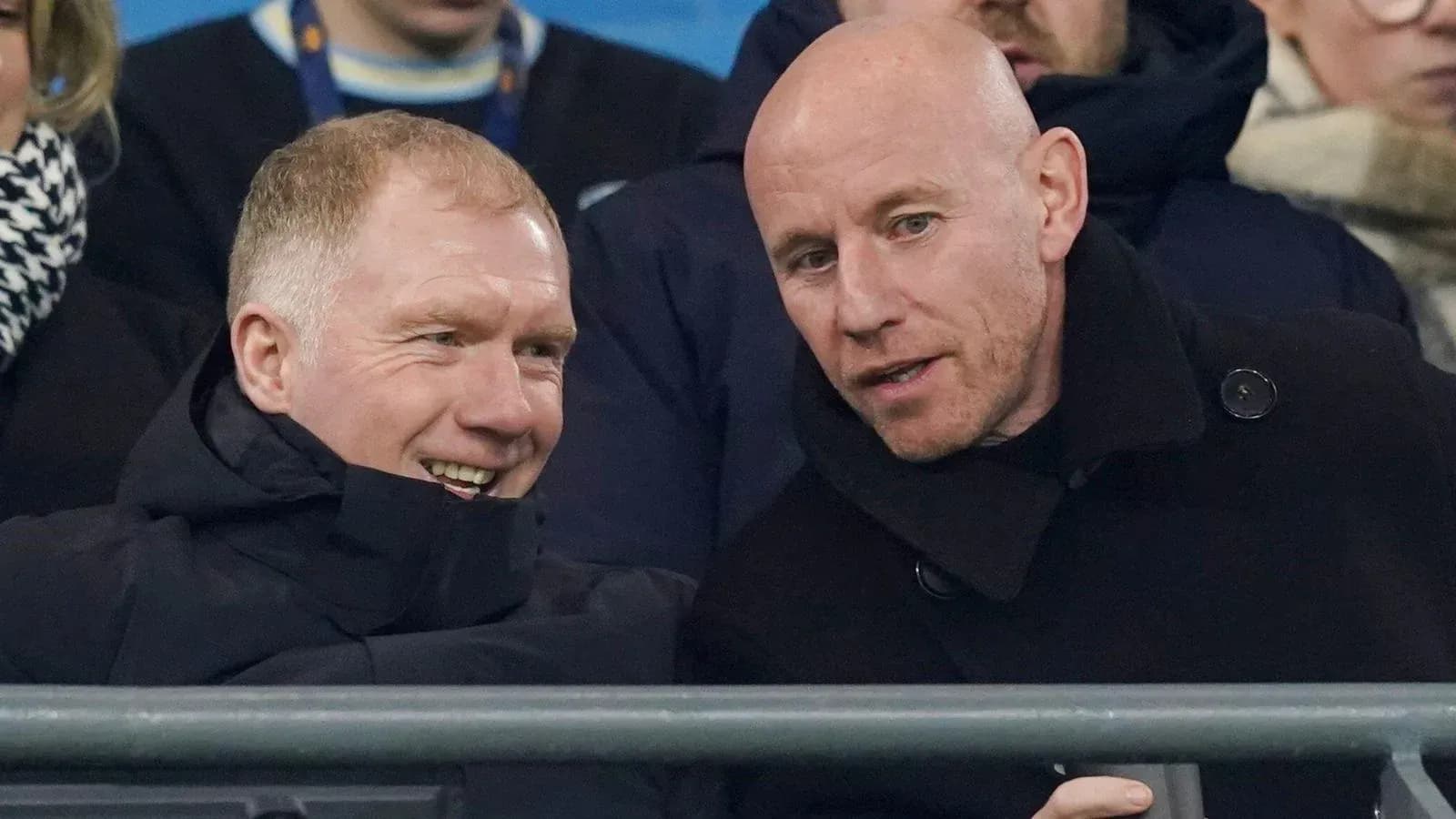 Two men chatting in the stands at a match Two men chatting in the stands at a match