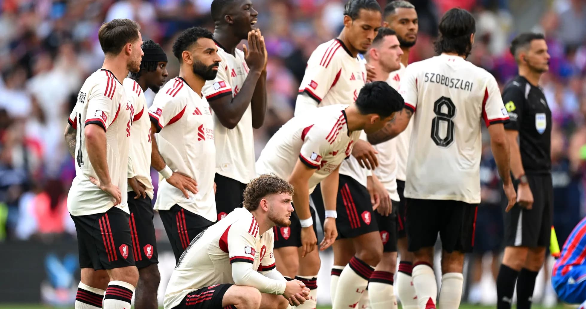 Players in white jerseys standing in a line Players in white jerseys standing in a line