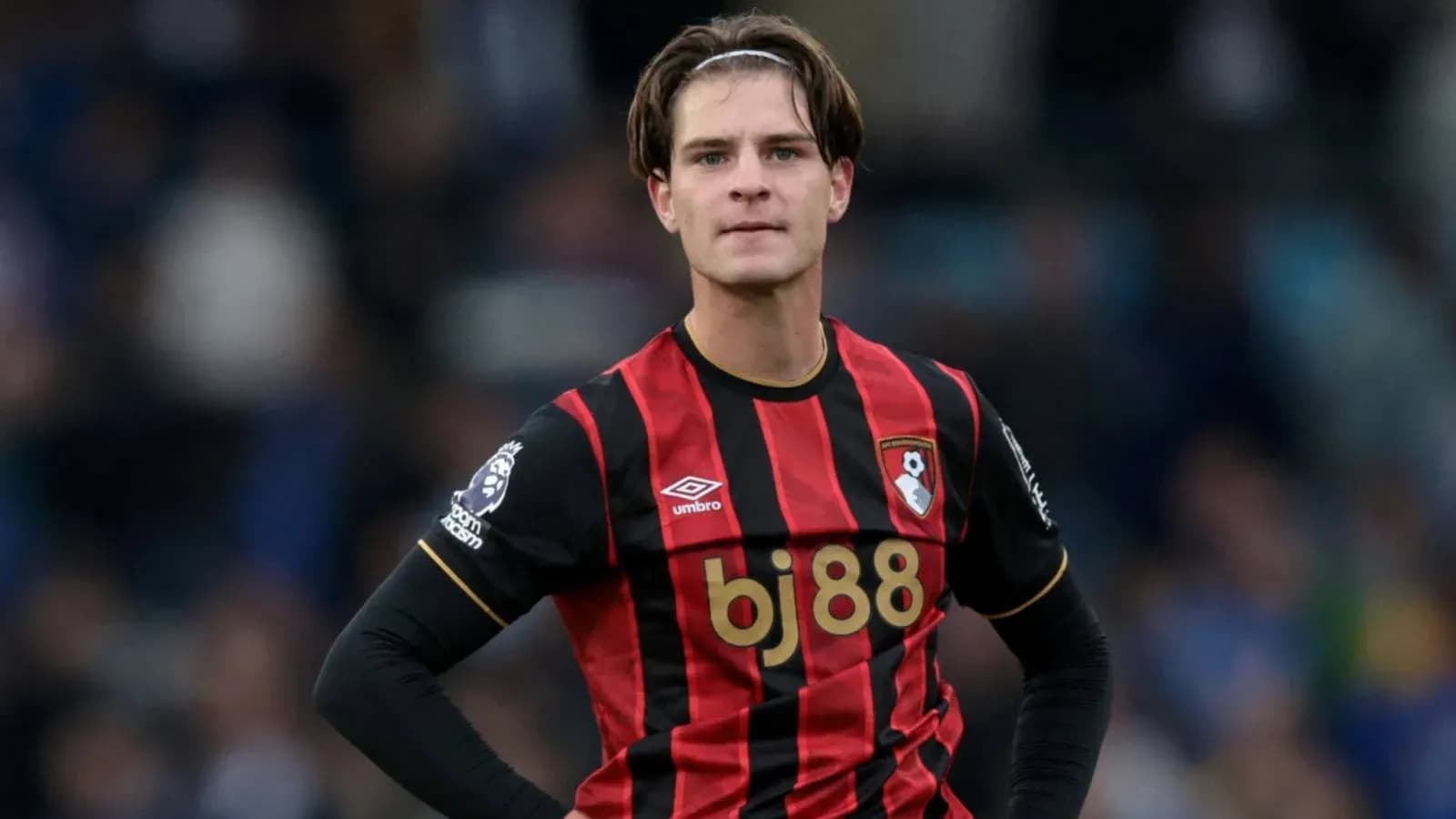 Bournemouth player in black and red jersey on field Bournemouth player in black and red jersey on field
