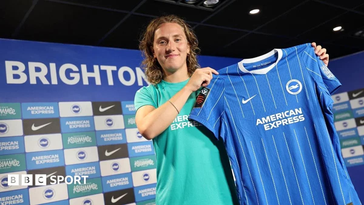 Player holding Brighton jersey at press conference Player holding Brighton jersey at press conference