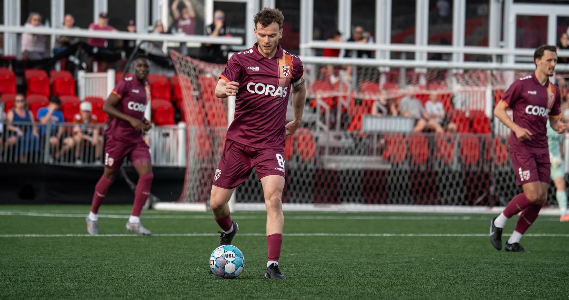 Player dribbling the ball during football match Player dribbling the ball during football match