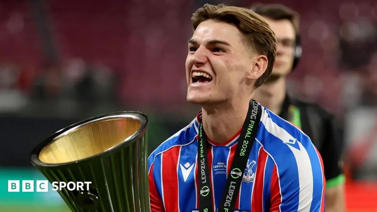 Player celebrating with trophy after winning match Player celebrating with trophy after winning match