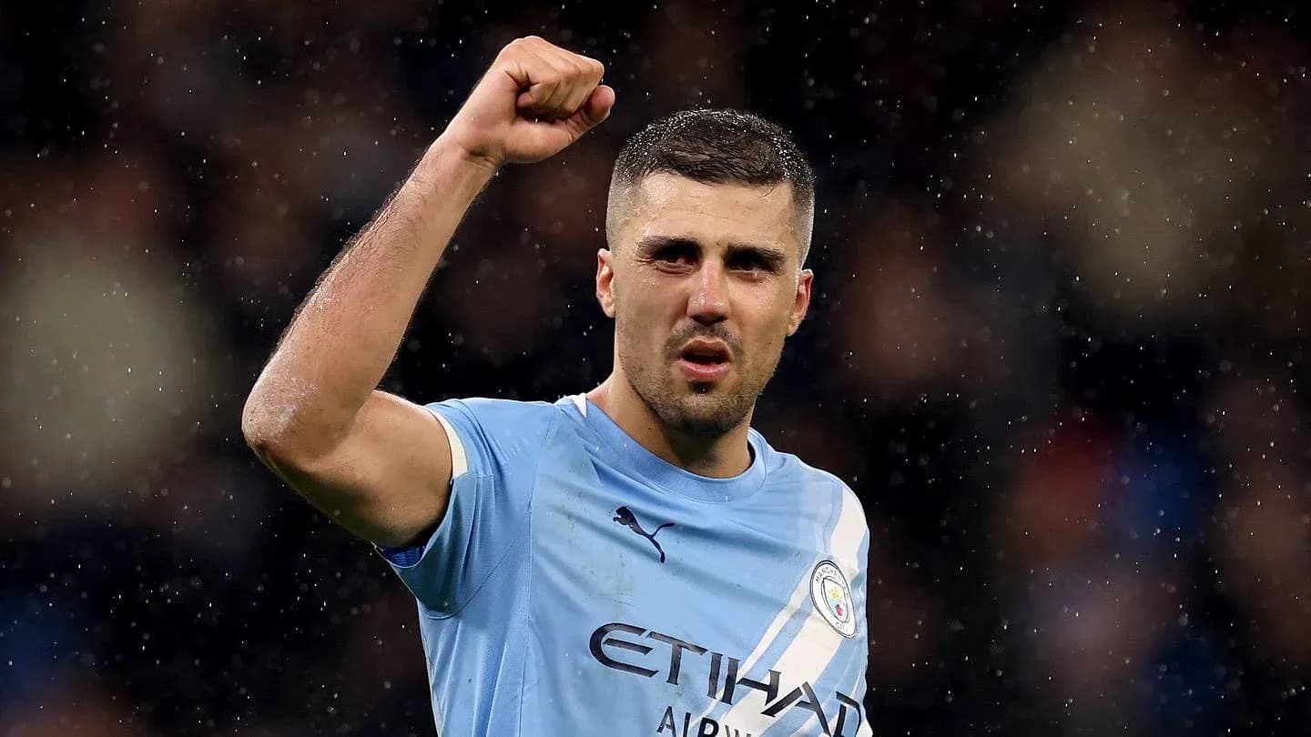 Player celebrating victory with raised fist on pitch Player celebrating victory with raised fist on pitch