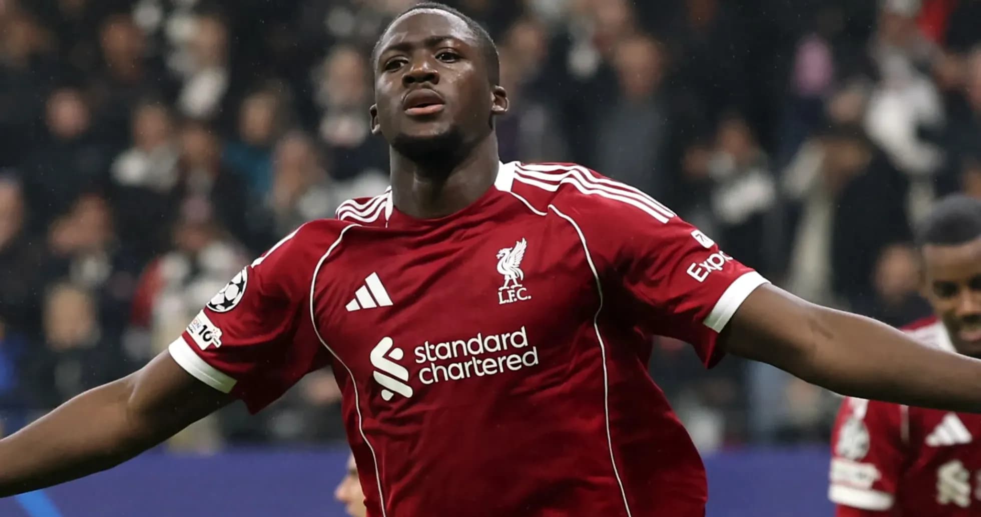 Player celebrating a goal in Liverpool jersey Player celebrating a goal in Liverpool jersey