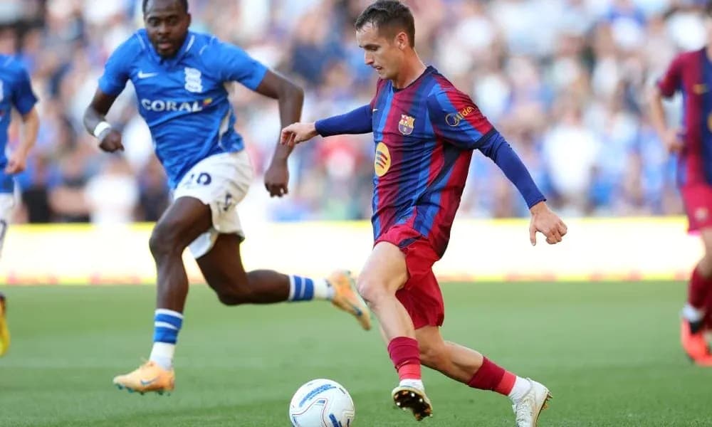 Barcelona player dribbling past Birmingham defender Barcelona player dribbling past Birmingham defender