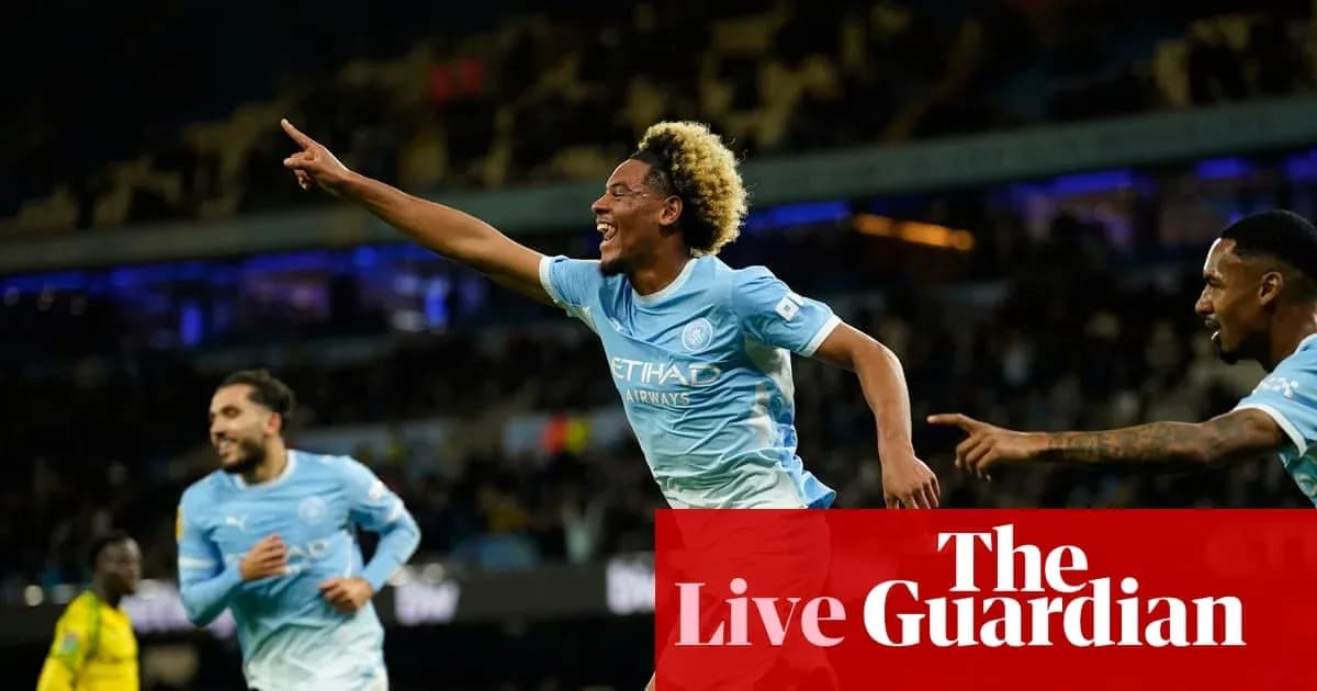 Player celebrating a goal with teammates on pitch Player celebrating a goal with teammates on pitch