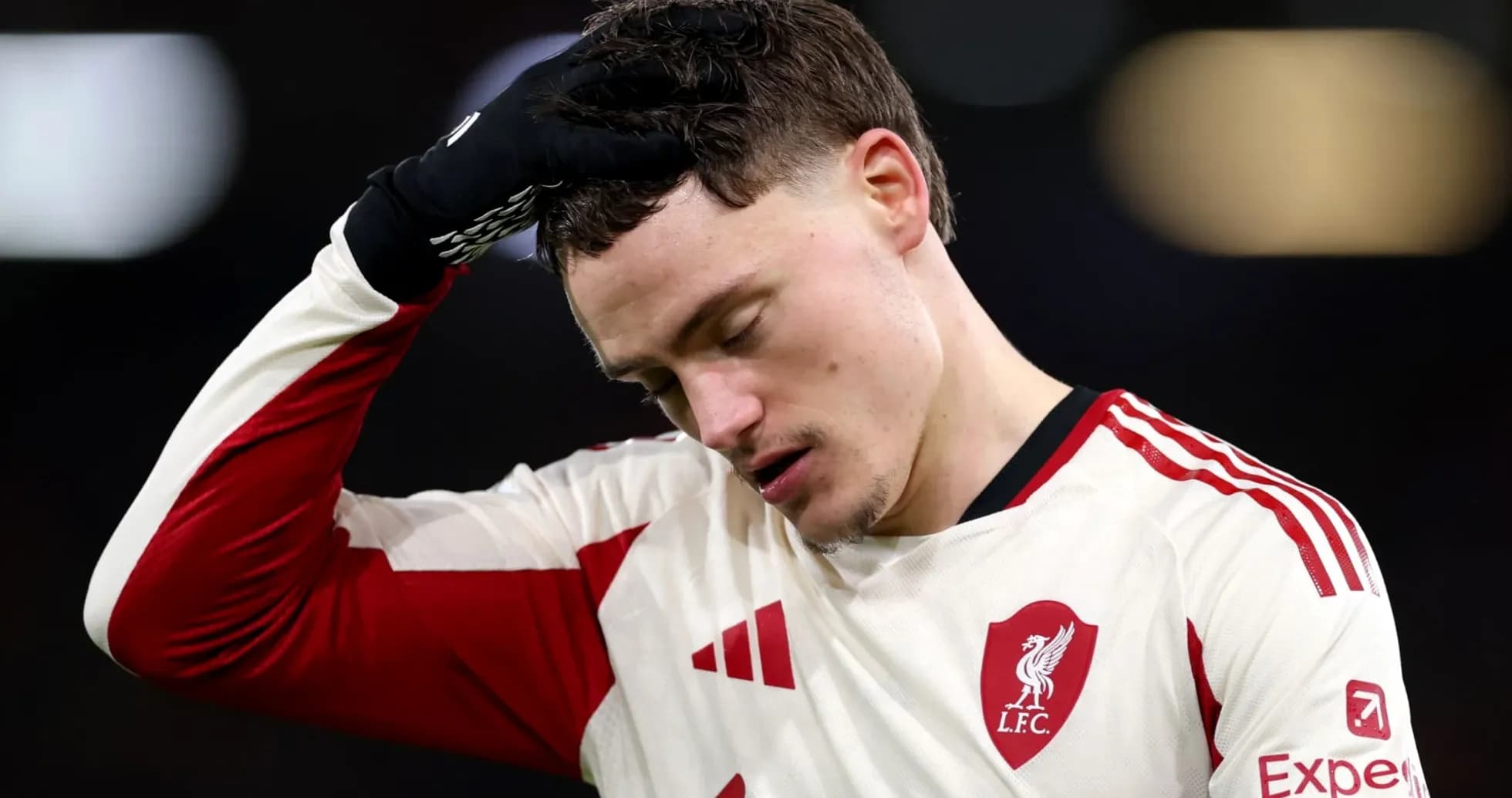 Player in Liverpool kit with hand on head Player in Liverpool kit with hand on head