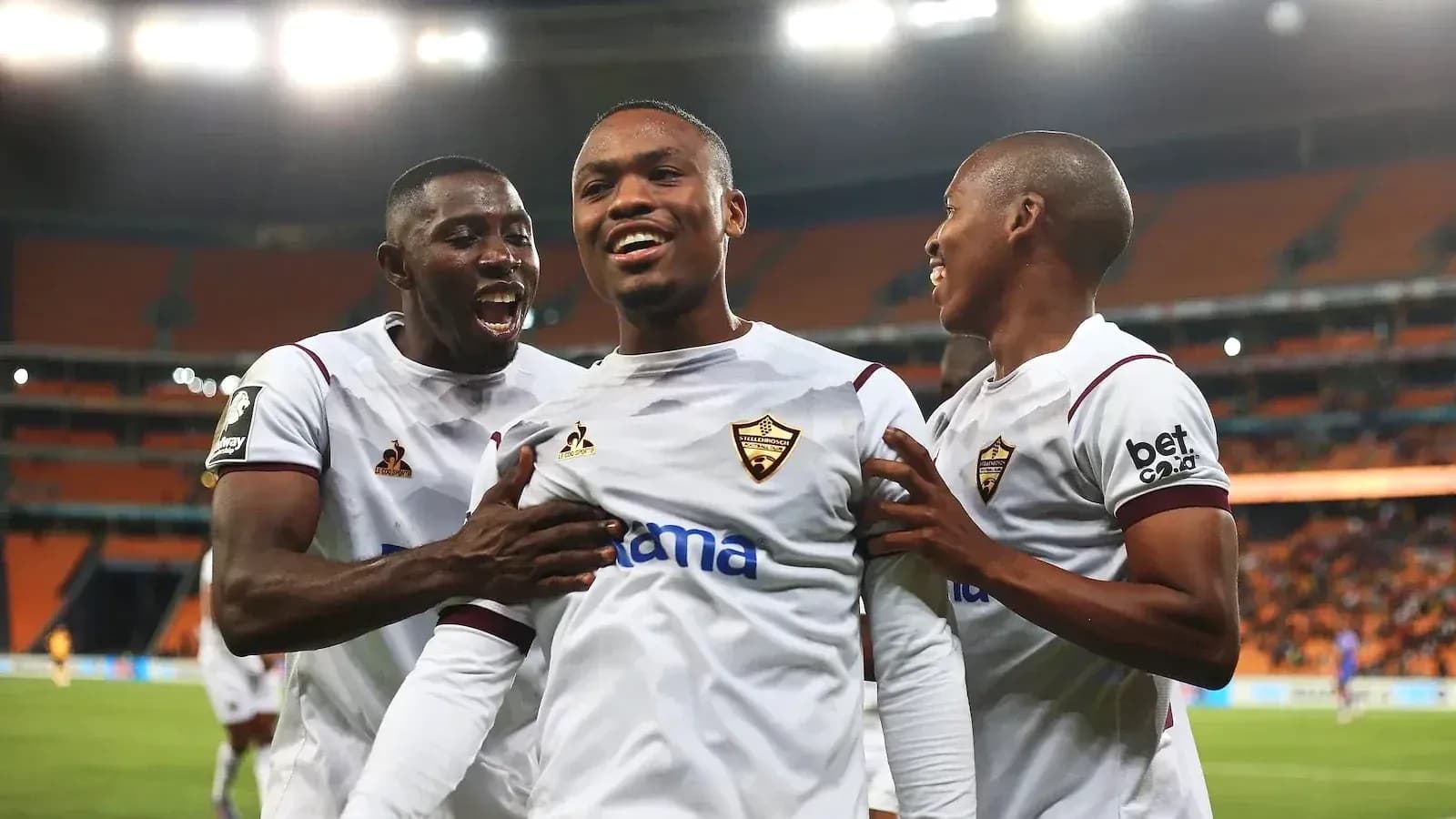 Players celebrating a goal in a football match Players celebrating a goal in a football match