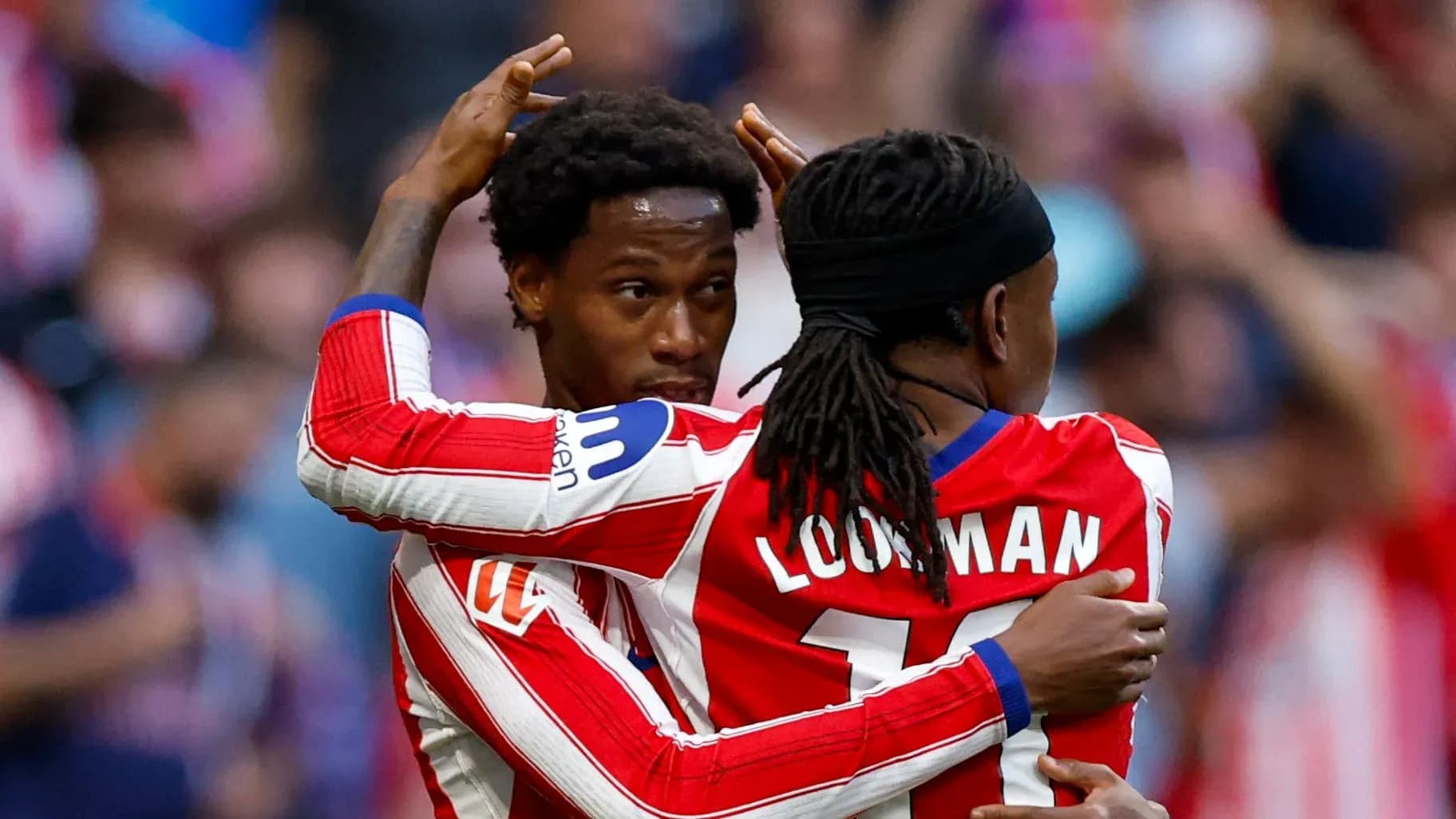 Two players celebrating a goal on the field Two players celebrating a goal on the field