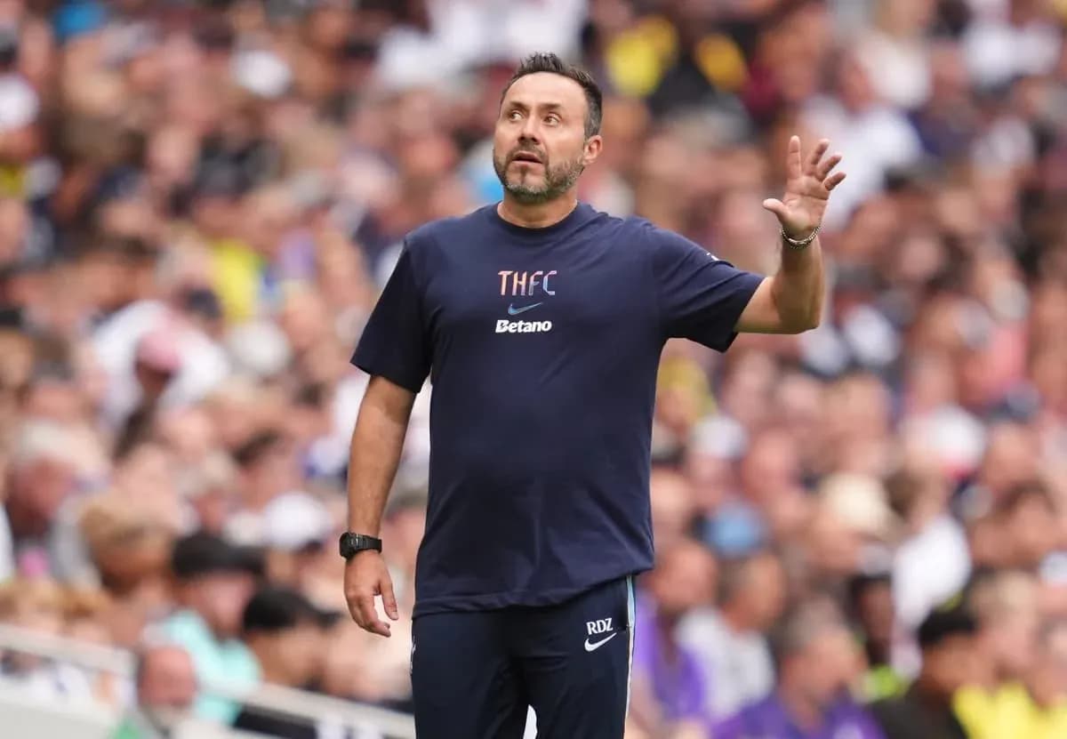 Coach gesturing during match in front of crowd Coach gesturing during match in front of crowd