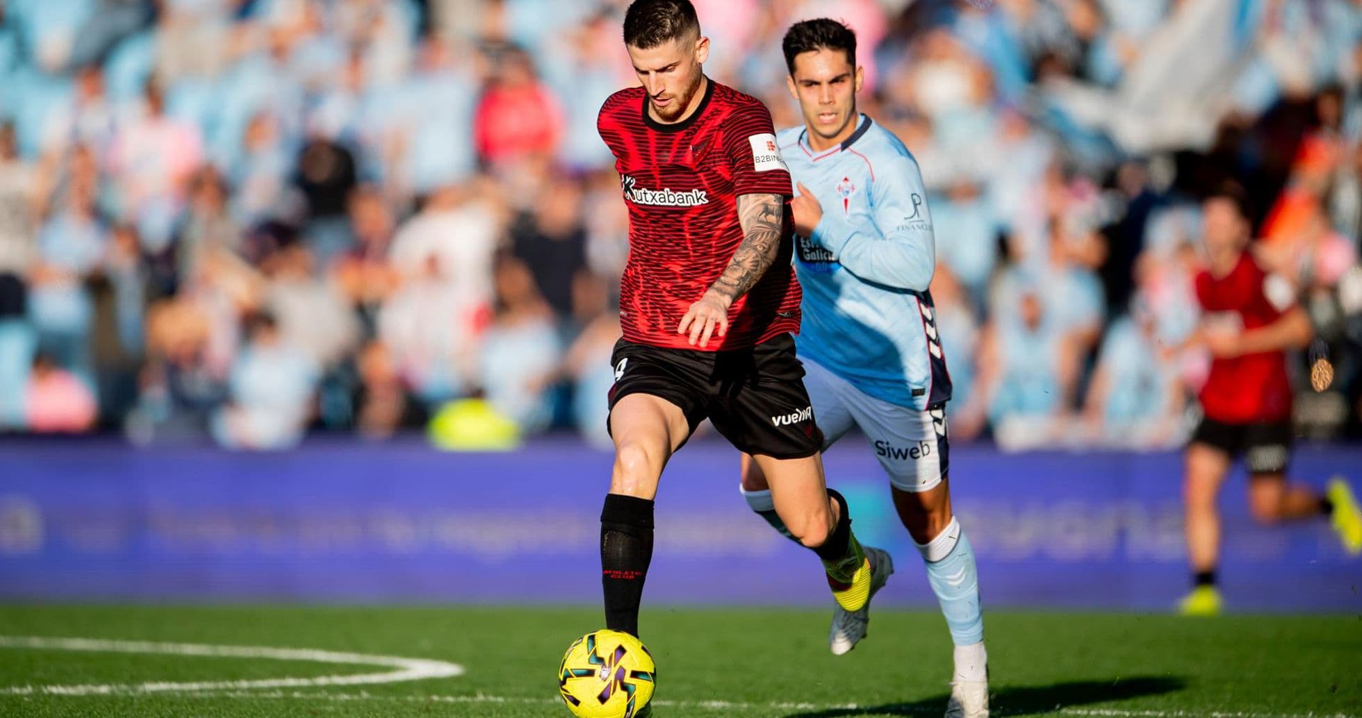 Athletic Club player dribbling past Celta Vigo opponent Athletic Club player dribbling past Celta Vigo opponent