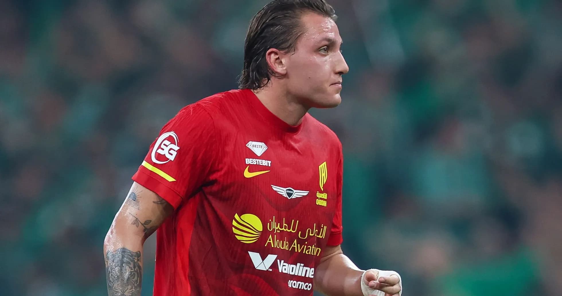 Player in red jersey during a football match Player in red jersey during a football match
