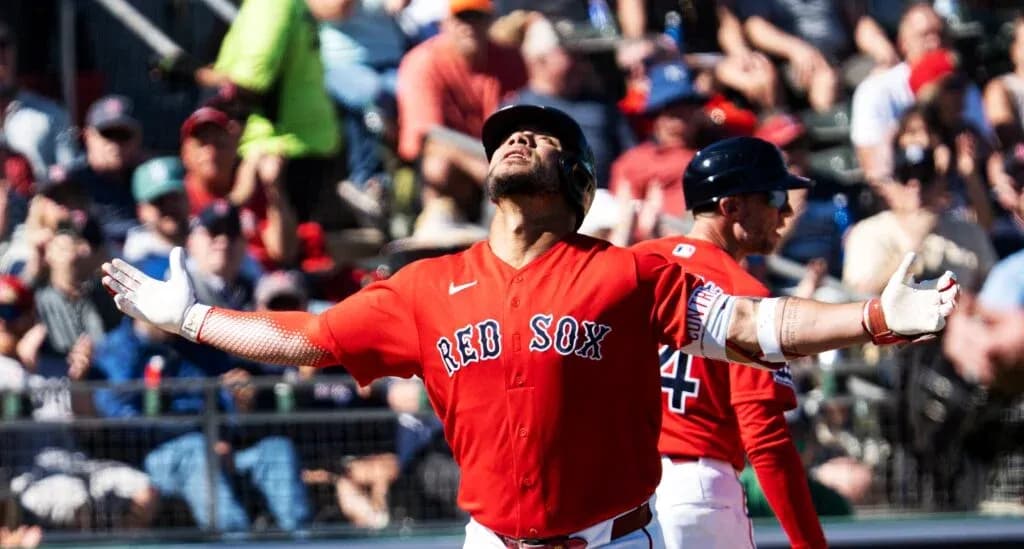 Red Sox player celebrating a hit with fans in background Red Sox player celebrating a hit with fans in background