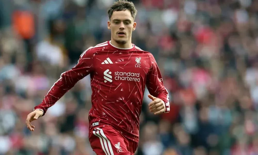 Player running on field wearing Liverpool jersey Player running on field wearing Liverpool jersey