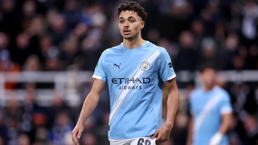 Player in light blue Manchester City jersey on pitch Player in light blue Manchester City jersey on pitch