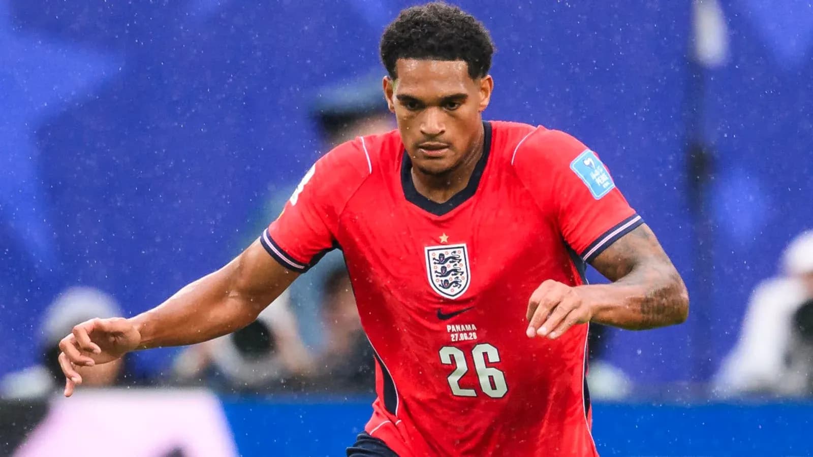 Player running during a football match wearing England kit Player running during a football match wearing England kit
