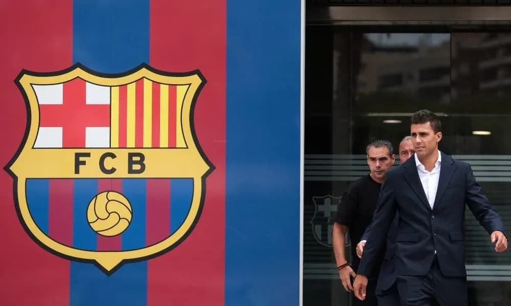 Player exiting building next to FC Barcelona logo Player exiting building next to FC Barcelona logo