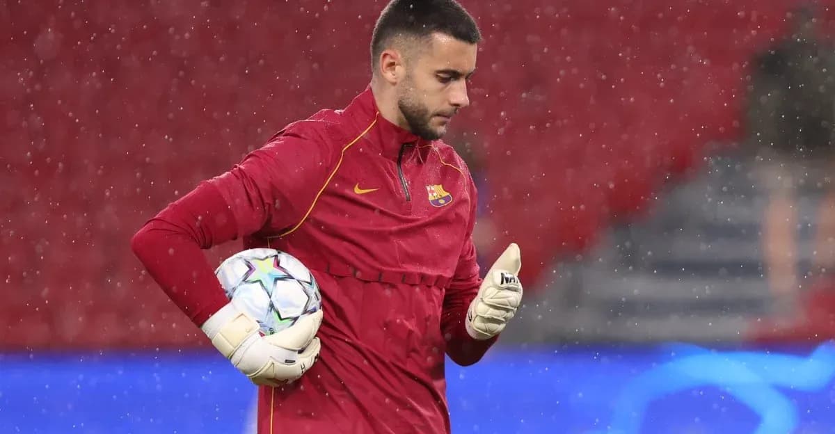 Goalkeeper in red training gear holding a ball Goalkeeper in red training gear holding a ball