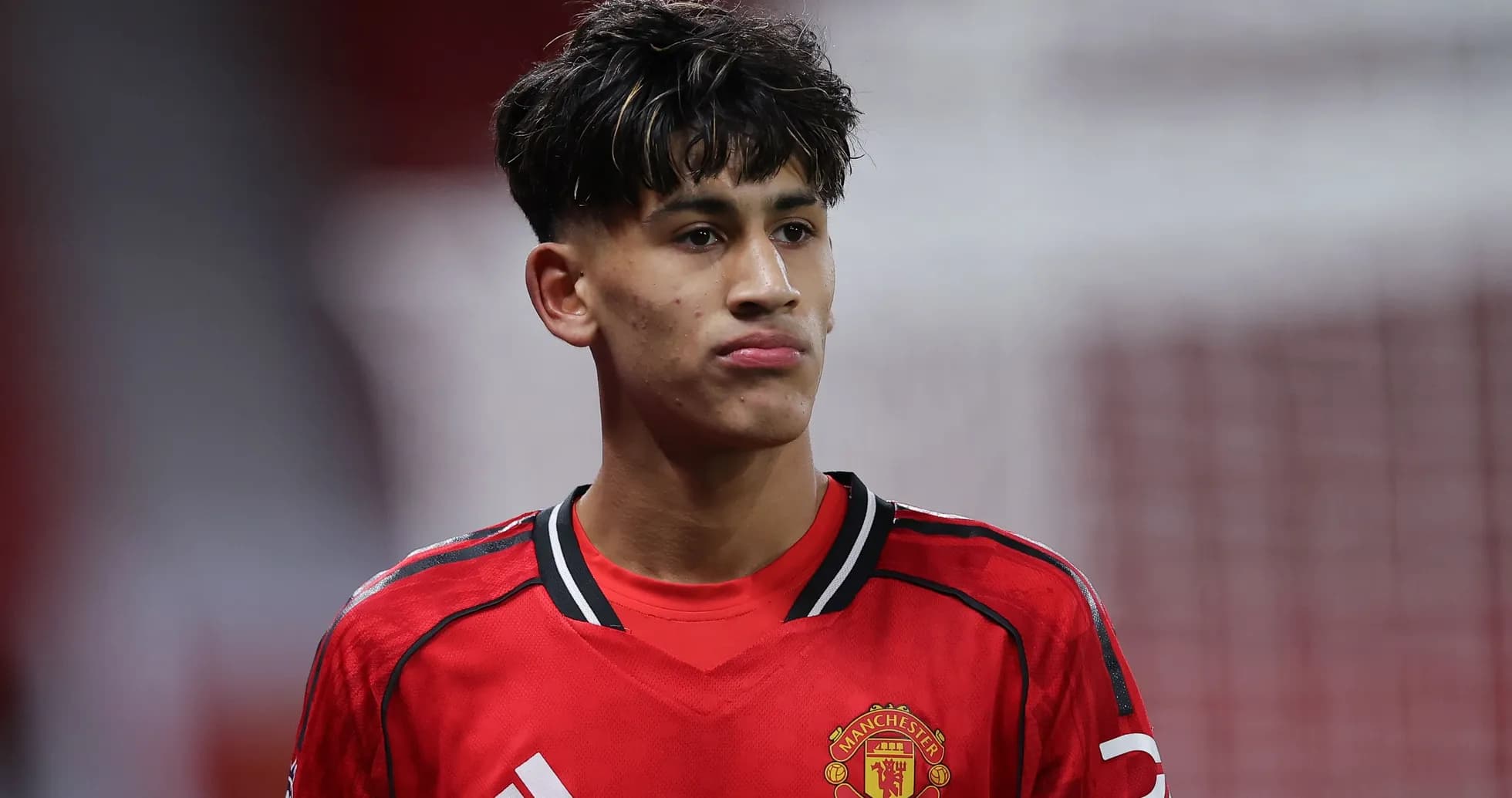 Player wearing Manchester United jersey on field Player wearing Manchester United jersey on field