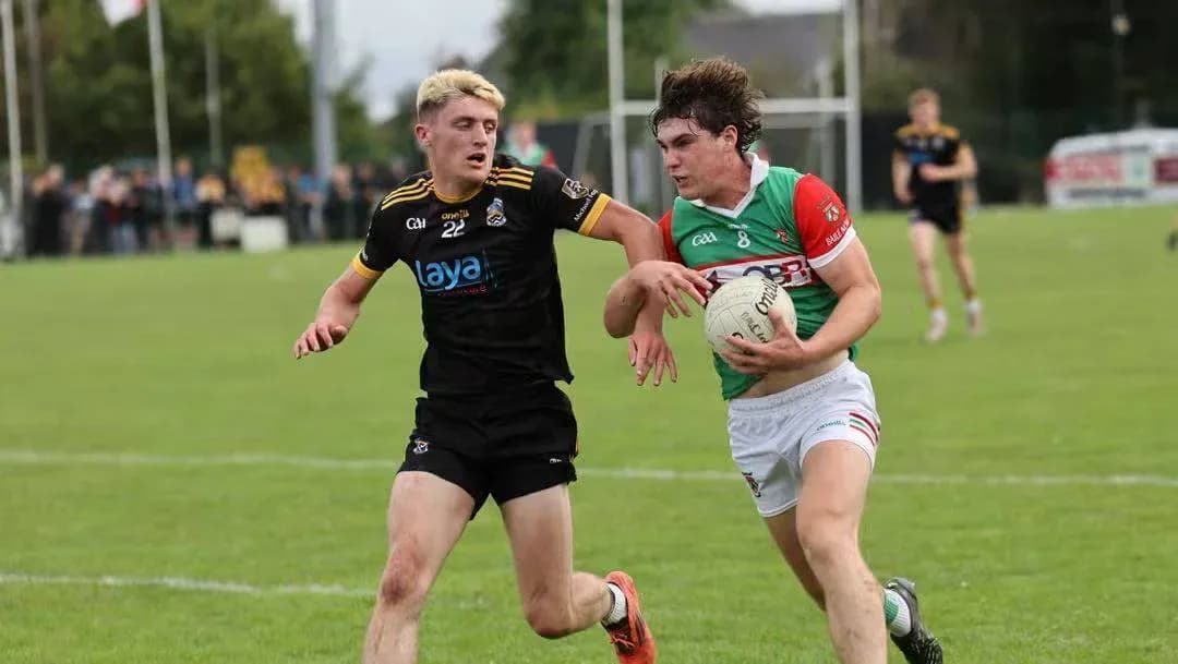 Two players competing for possession of the ball Two players competing for possession of the ball