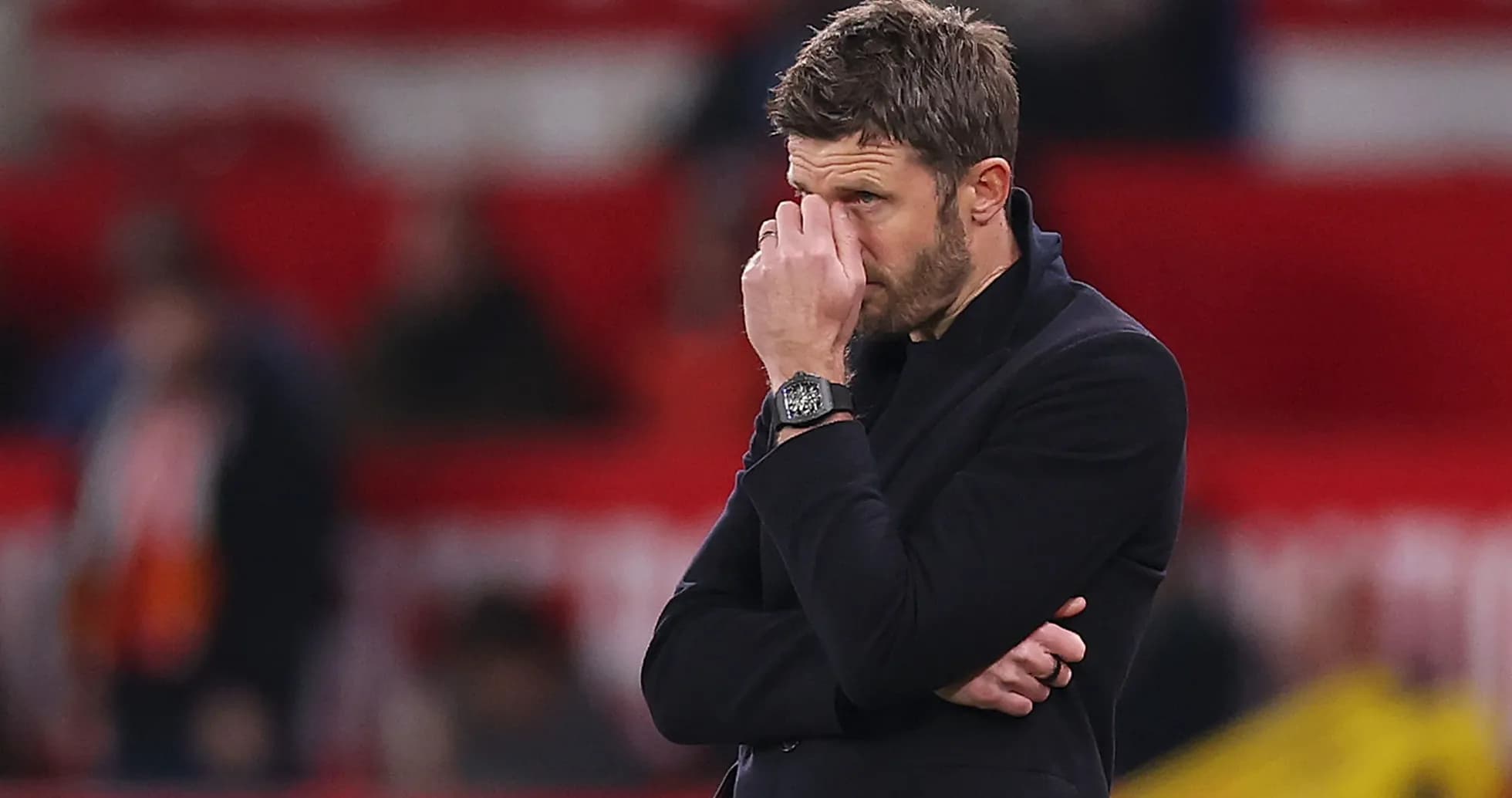 Manager with hand on face during match Manager with hand on face during match