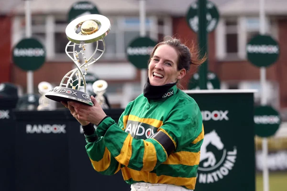 Jockey celebrating with trophy after winning race Jockey celebrating with trophy after winning race