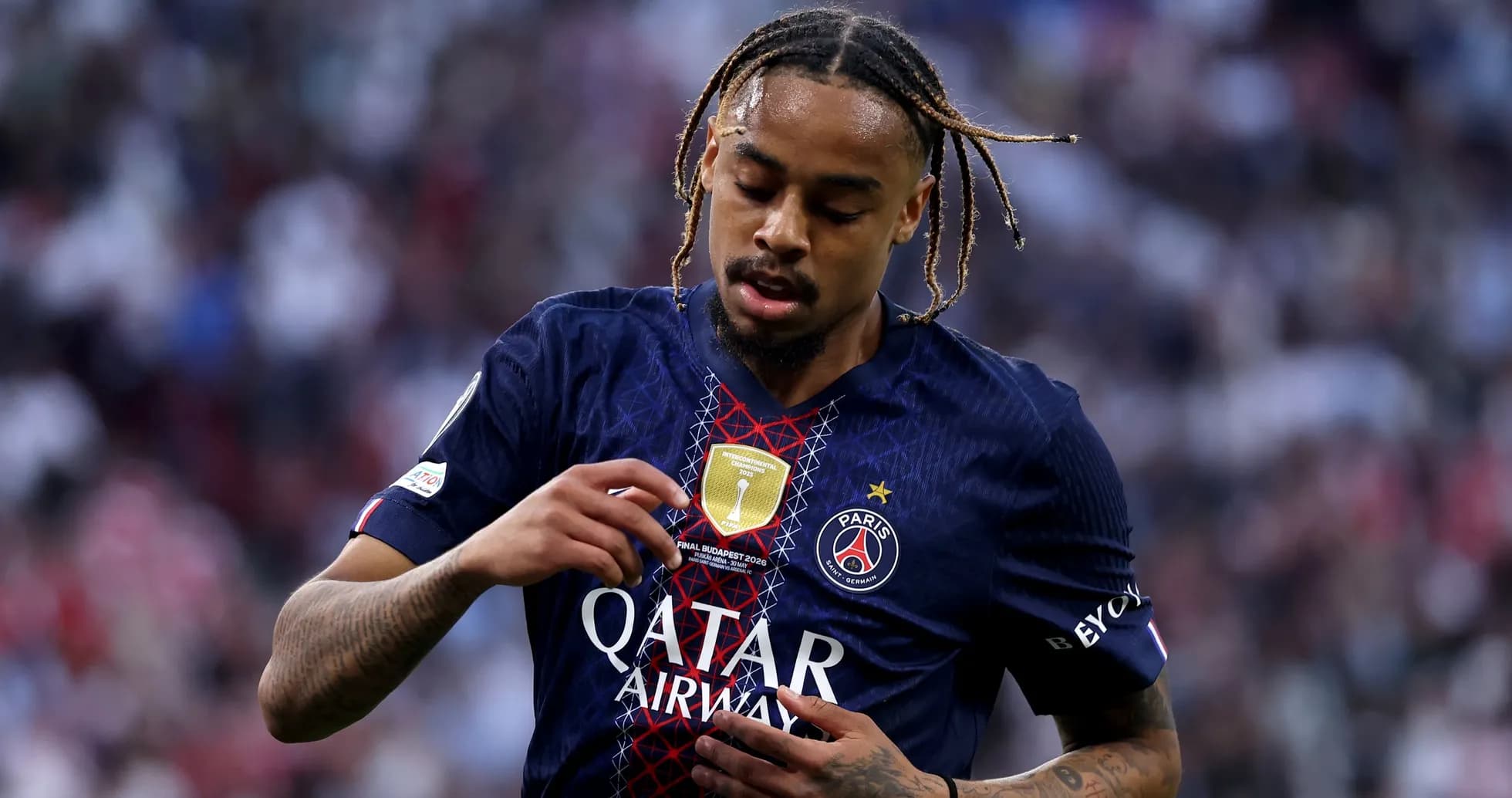 Player adjusting jersey with club badge during match Player adjusting jersey with club badge during match