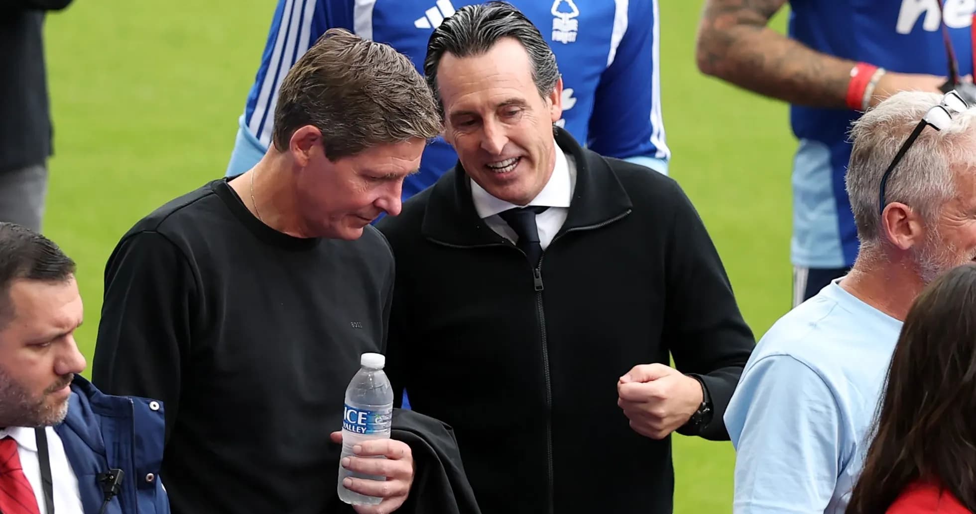 Two coaches talking on the pitch before match Two coaches talking on the pitch before match