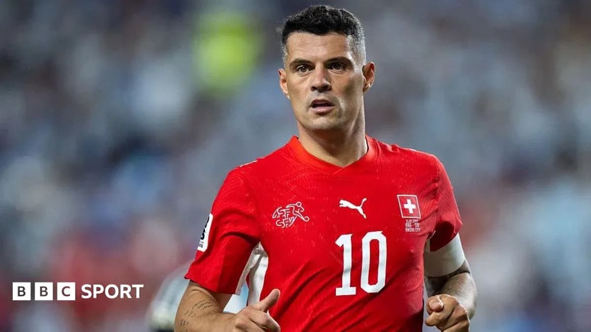 Player in red jersey during a football match Player in red jersey during a football match