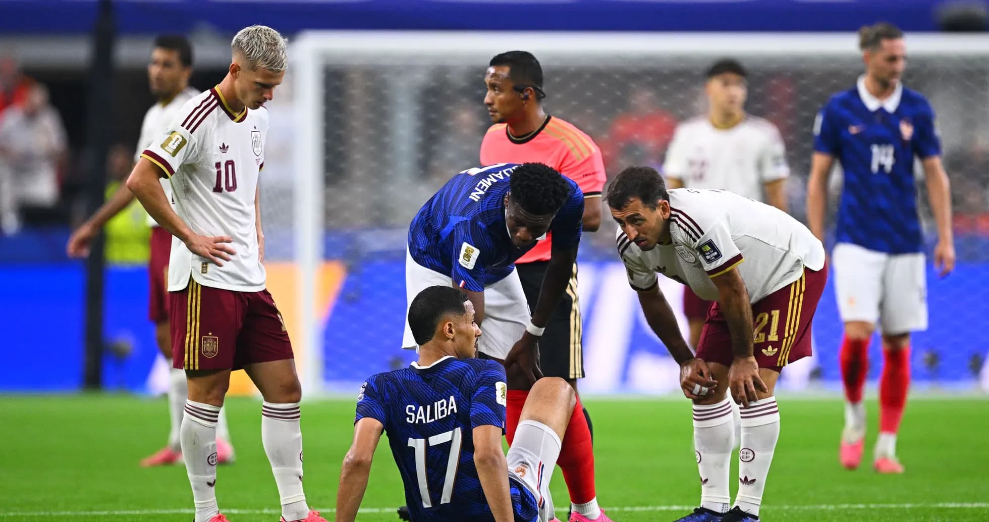 Players attending to injured player during match Players attending to injured player during match