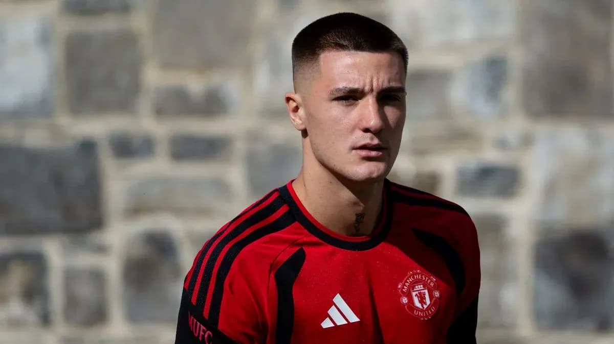 Player in Manchester United training kit on pitch Player in Manchester United training kit on pitch