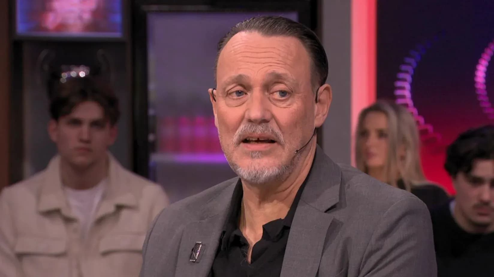 Man speaking during a talk show segment Man speaking during a talk show segment