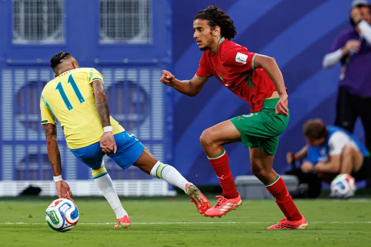 Player in yellow dribbling past opponent in red Player in yellow dribbling past opponent in red