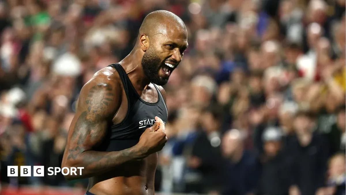 Athlete celebrating passionately in front of crowd Athlete celebrating passionately in front of crowd