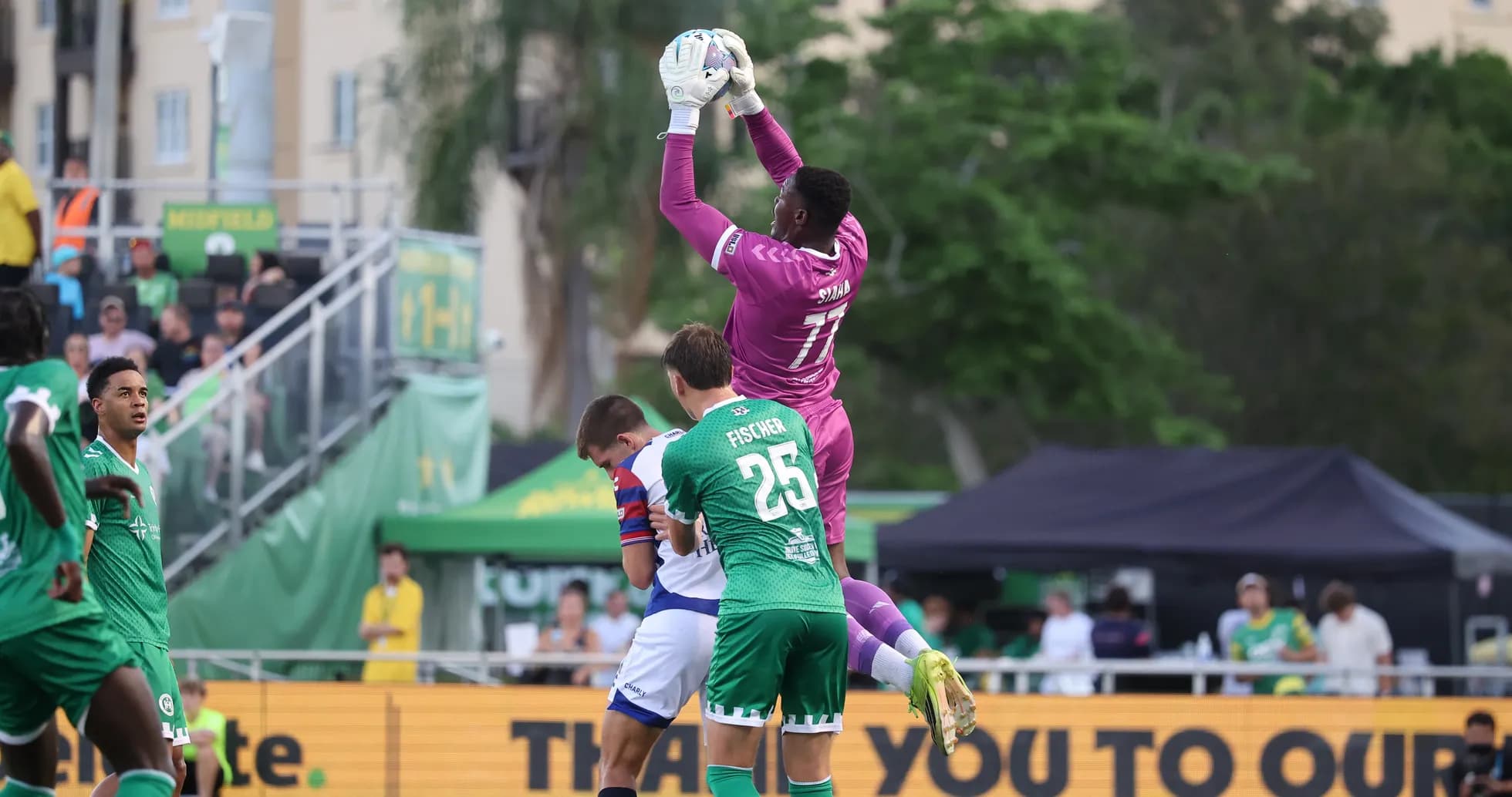 Goalkeeper catching the ball during match action Goalkeeper catching the ball during match action