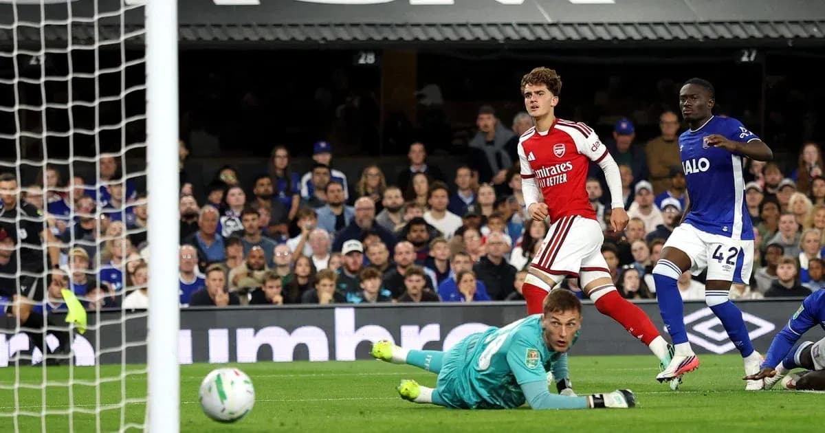 Arsenal player celebrates after scoring against opponent Arsenal player celebrates after scoring against opponent