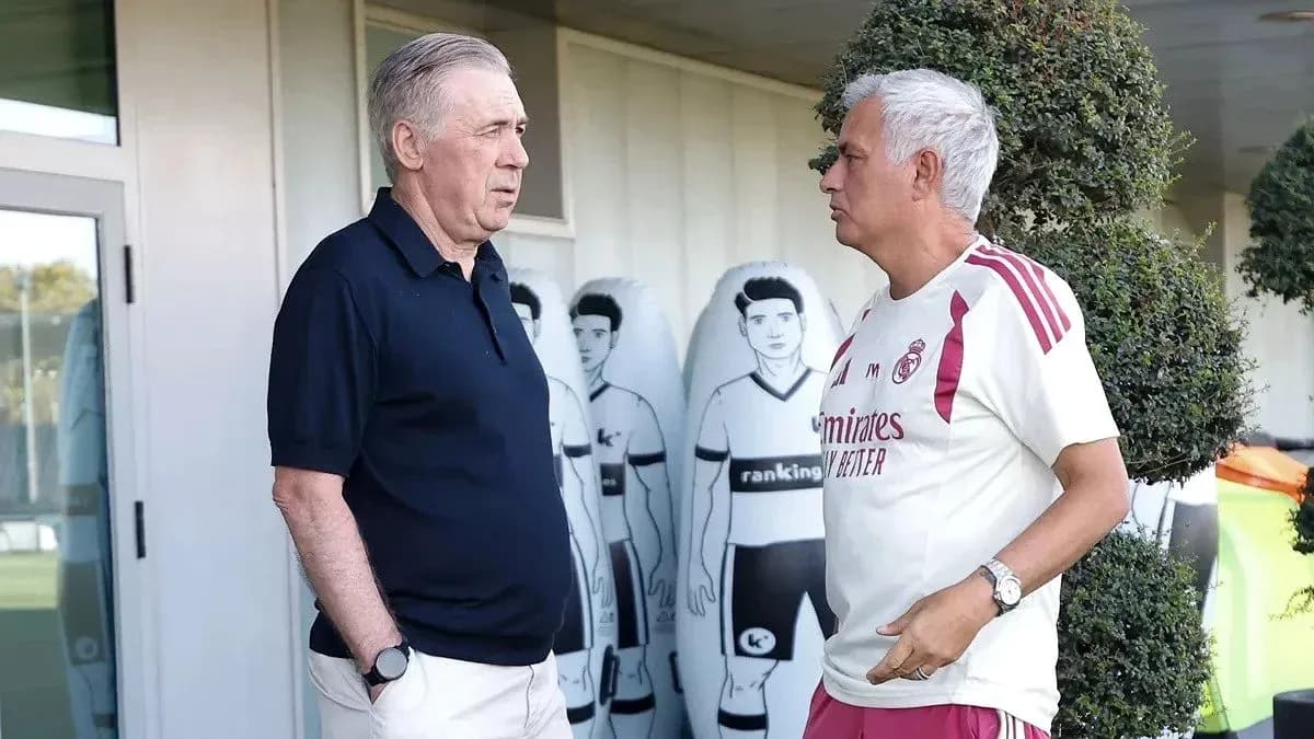 Two football managers conversing at training ground Two football managers conversing at training ground