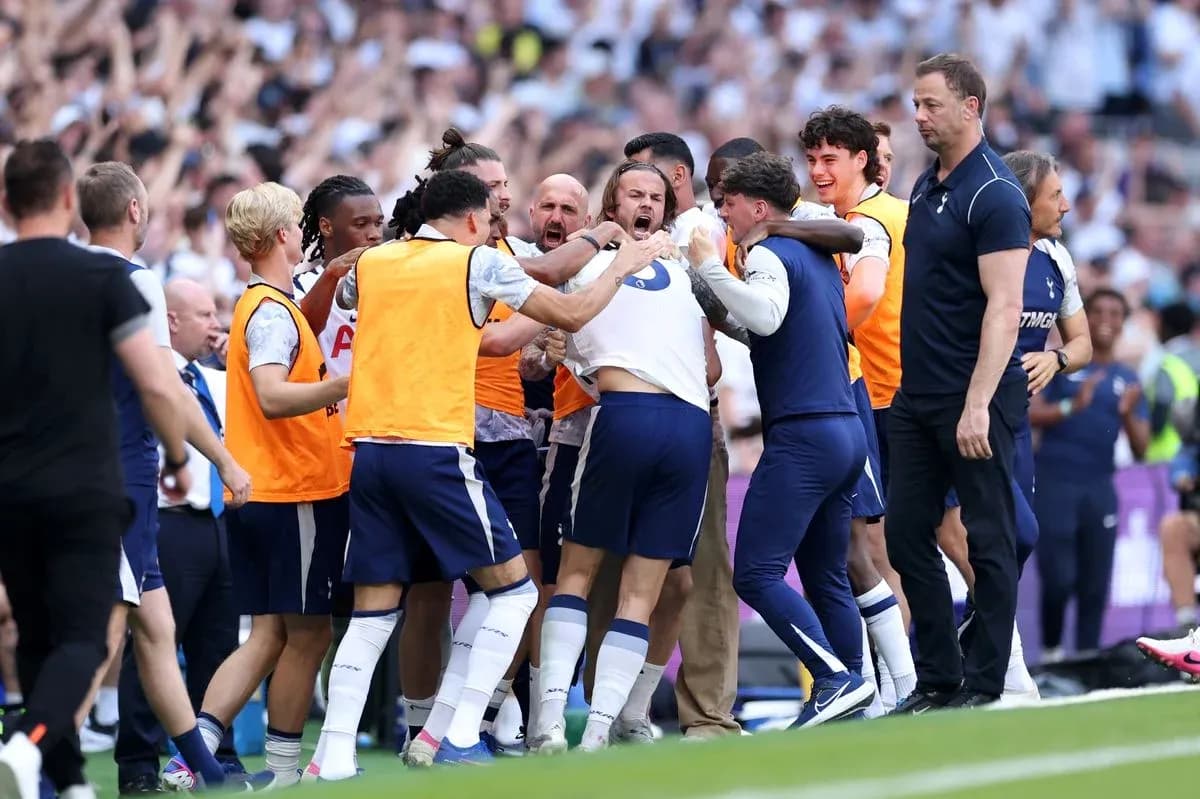 Tottenham players celebrating a goal on the pitch Tottenham players celebrating a goal on the pitch