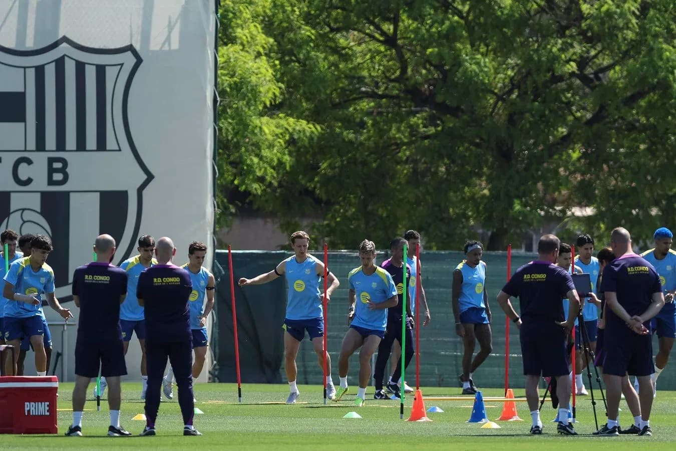 Barcelona players training on the pitch with cones Barcelona players training on the pitch with cones