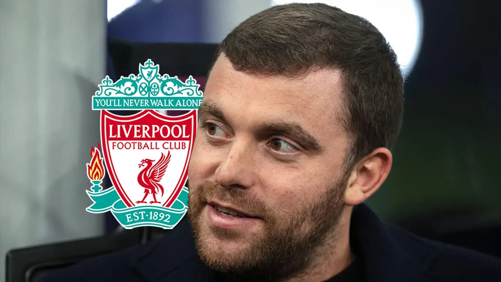 Man with beard and Liverpool FC logo in background Man with beard and Liverpool FC logo in background