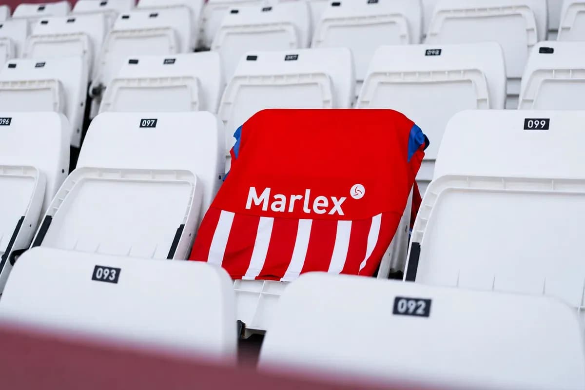 Red jersey with white stripes on empty stadium seat Red jersey with white stripes on empty stadium seat