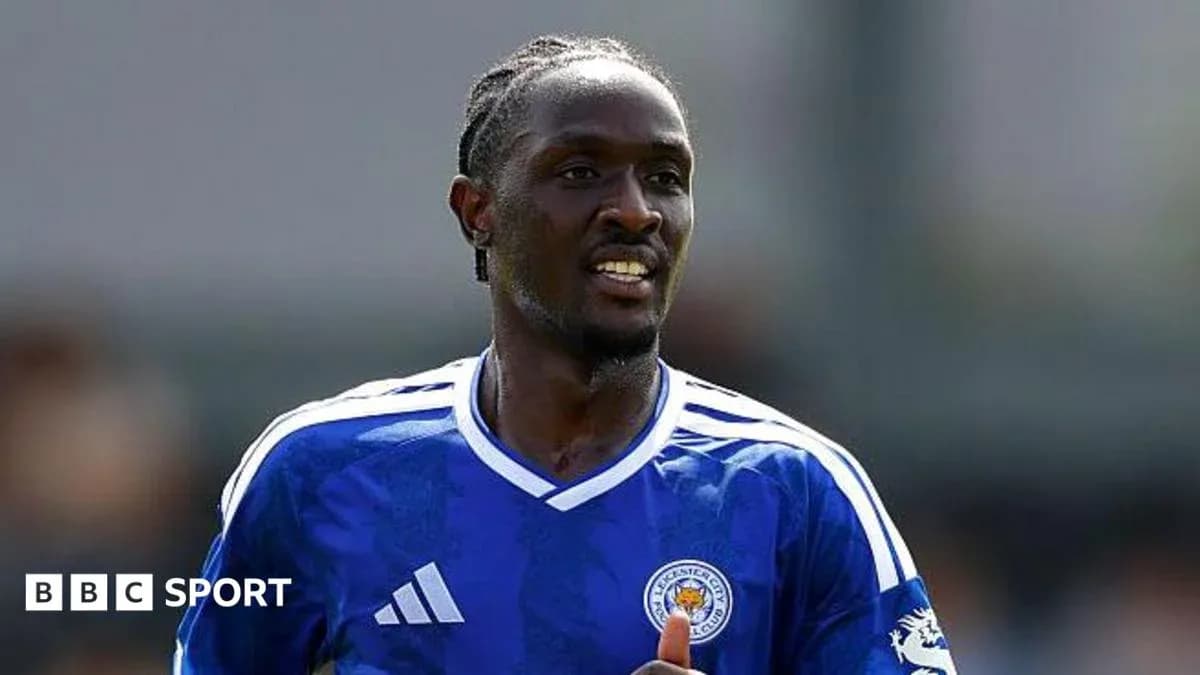 Player in blue Leicester City jersey on the field Player in blue Leicester City jersey on the field